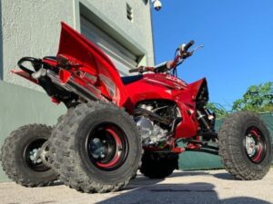 side view of a red ATV