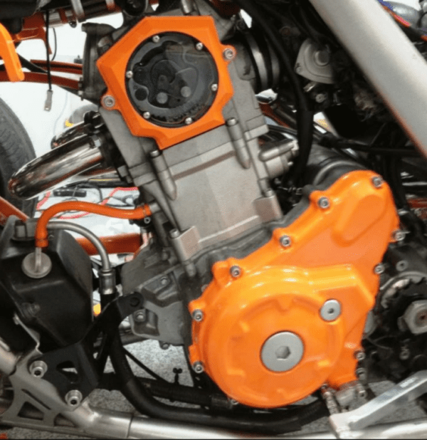 A Bike Engine With Orange Colo Covers